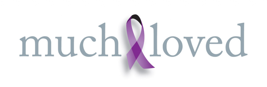 Image shows the Much Loved logo which is the words much loved with a purple ribbon in the middle.