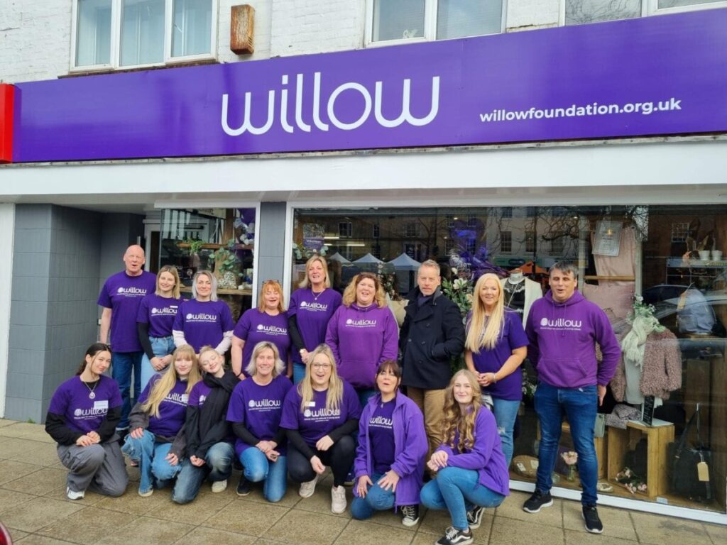 Photo of people in purple Willow t-shirts stood inside the new store in Hertford