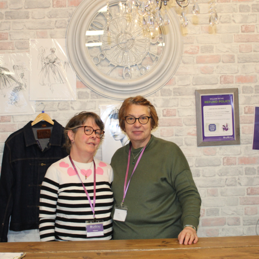 Two women volunteering at a Willow shop