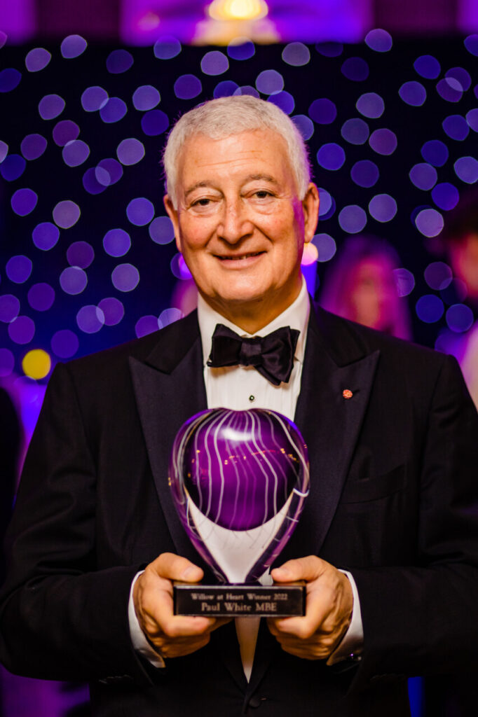 A photo of Paul White MBE in a suit at the Willow Ball