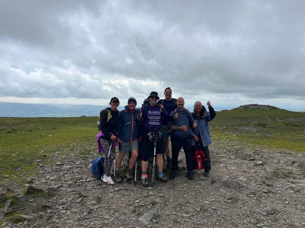 Rob is joined by family and friends at the top of one of the peaks during his double three peaks challenge. 