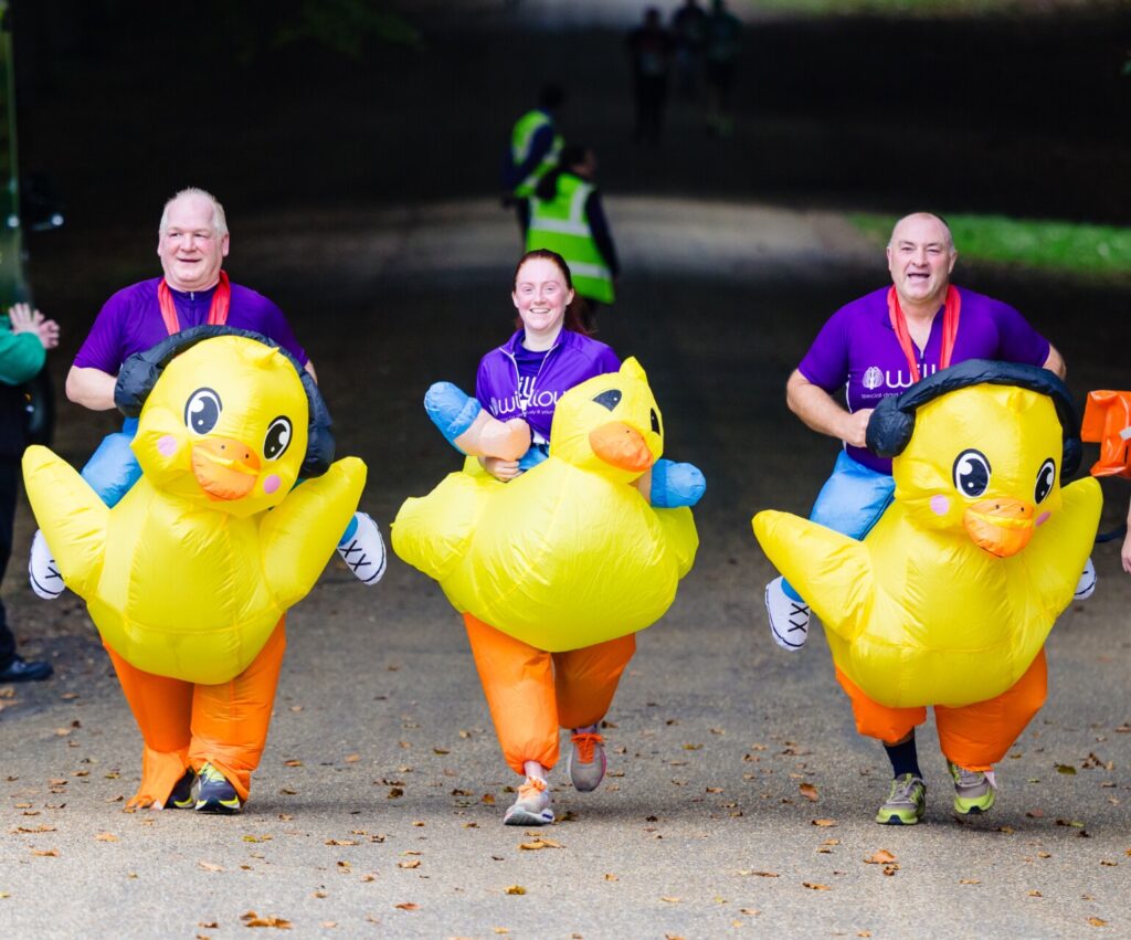 Graham (on the left), Charlotte (in the middle) and Grant (on the right) running the 10K in their inflatable duck costumes