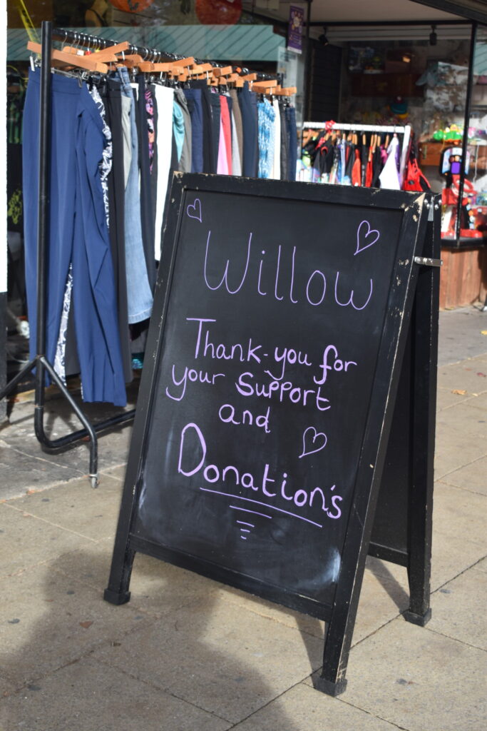 Chalkboard sign outside Willow Hatfield charity shop reads "Willow Thank you for your support and donations" 