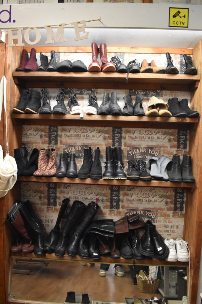 Preloved shoe shelf inside Hatfield's Willow charity shop