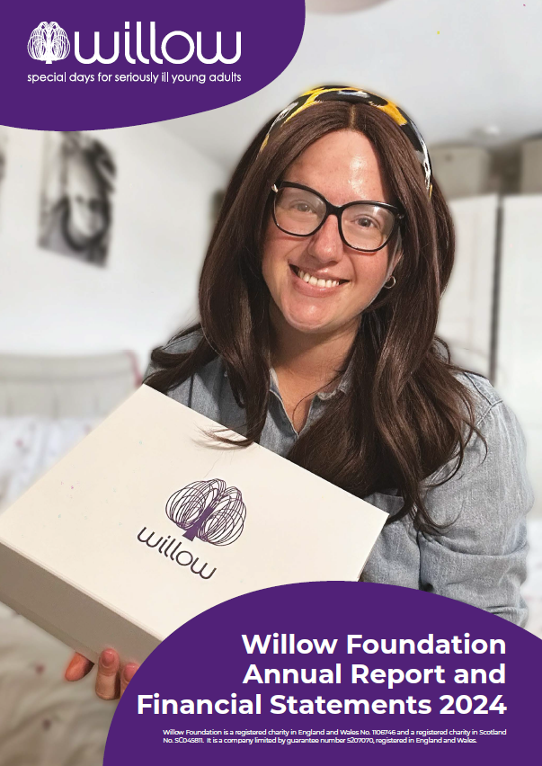 A picture of a young lady with breast cancer smiling and holding a gift box with a Willow Foundation logo on it