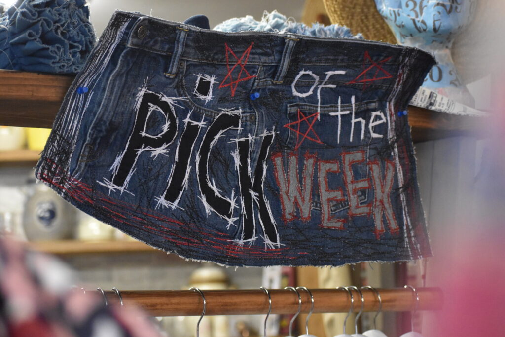 Inside Willow Biggleswade shop hand-sewn sign on recycled denim skirt reads "Pick of the Week"