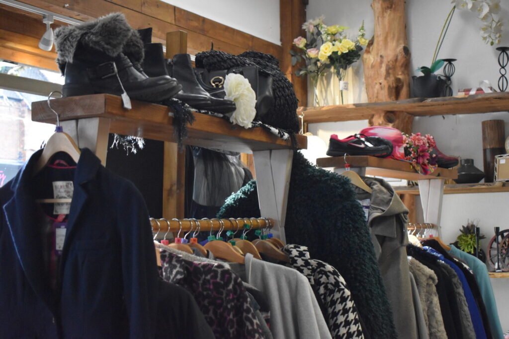 Stacked clothing rails and boots at Letchworth's Willow Charity shops