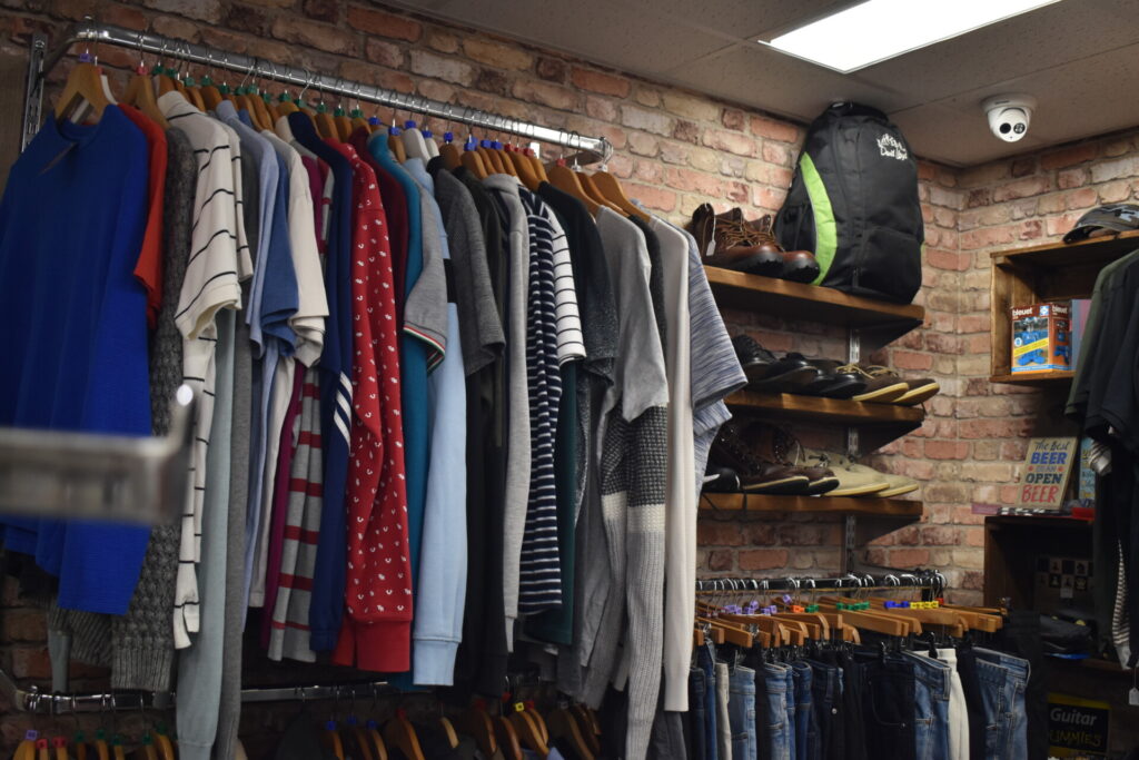 Men's shirts and shoes displayed in the newly refurbished Willow Stevenage charity shop.