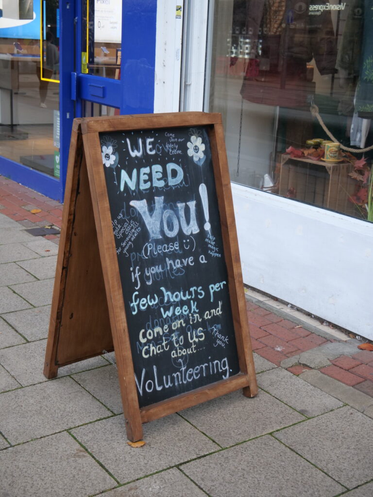 Sign outside Willow Hemel reads "We need you! (Please) if you have a few hours per week come on in and chat to us about... volunteering" 