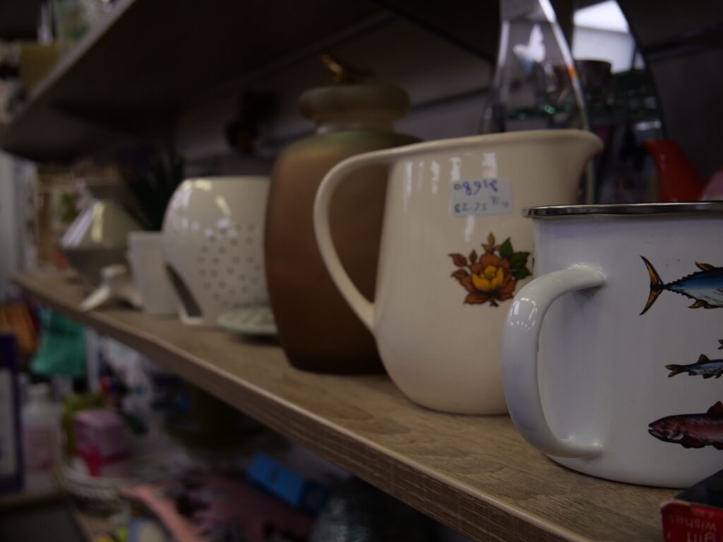 Shelf inside Willow Hemel shop with various items including mugs, pots and wax melt burners