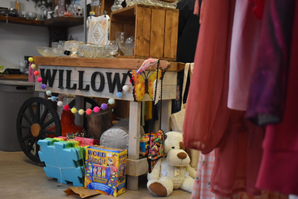 Stand inside Willow charity shop in Hertford, displaying children's toys and games