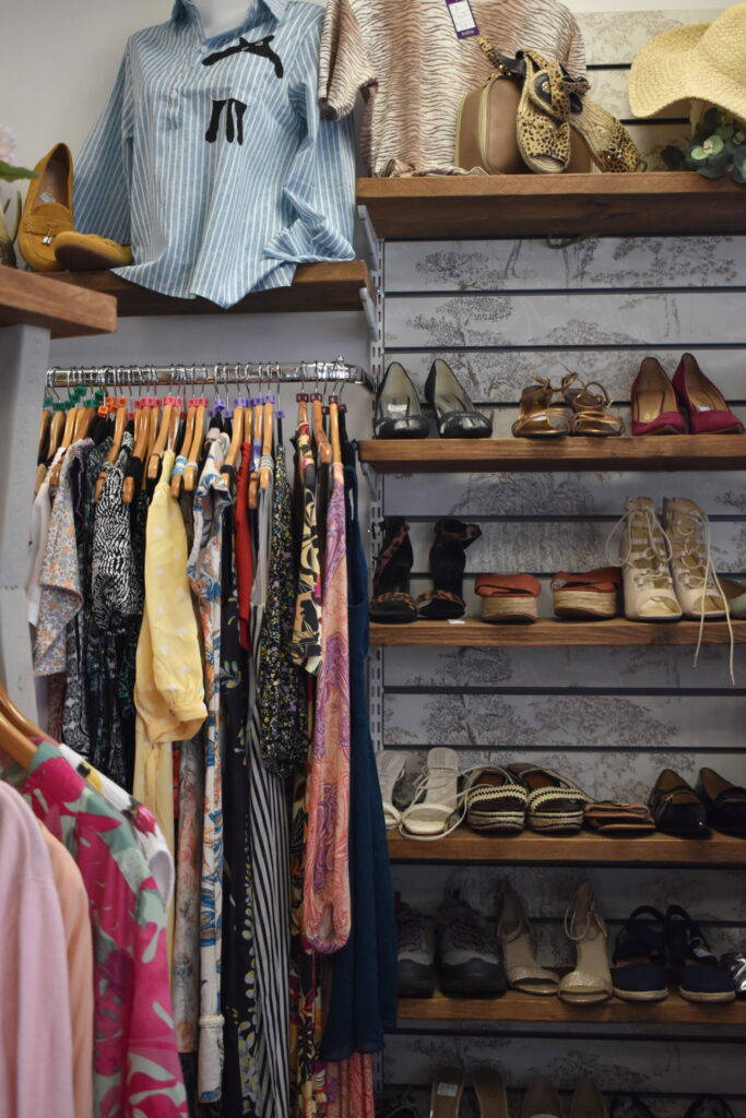 Inside Willow charity shop Hertford, racks of clothes and shoes