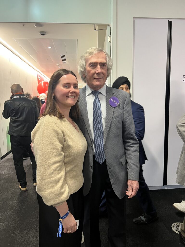 Pat Jennings smiles with staff at ICAP charity day