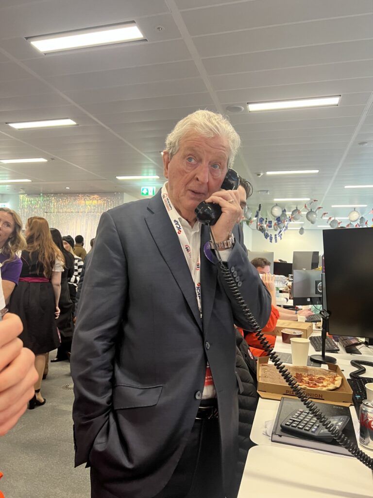 Roy Hodgson on the phone closing deals at ICAP Charity Day 2025