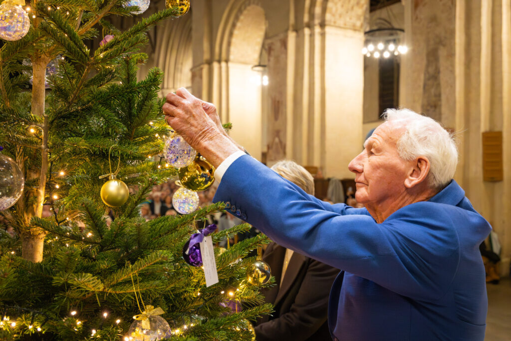 Willow Co-founder and Life President Bob Wilson hangs commemorative bauble in memory of his daughter Anna and wife Megs