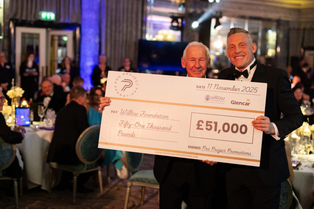 Graham Stack presents a cheque of £51,000 to Willow's co-founder and Life President Bob Wilson at the Willow Ball